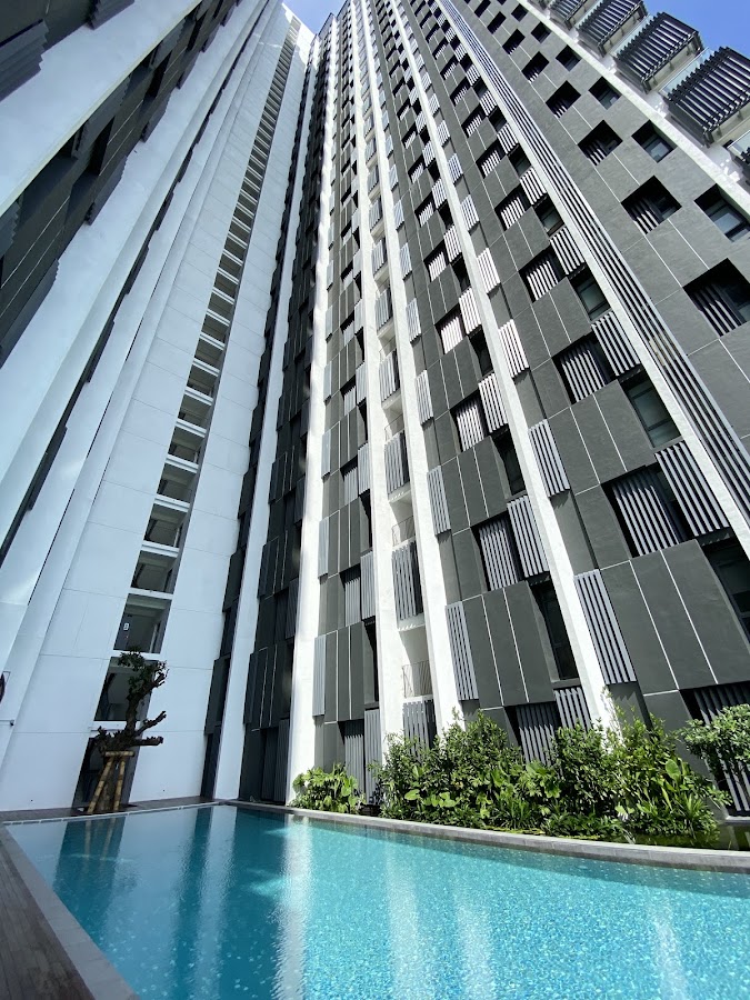 TWY Mont Kiara: the tower's facade rising from the pool