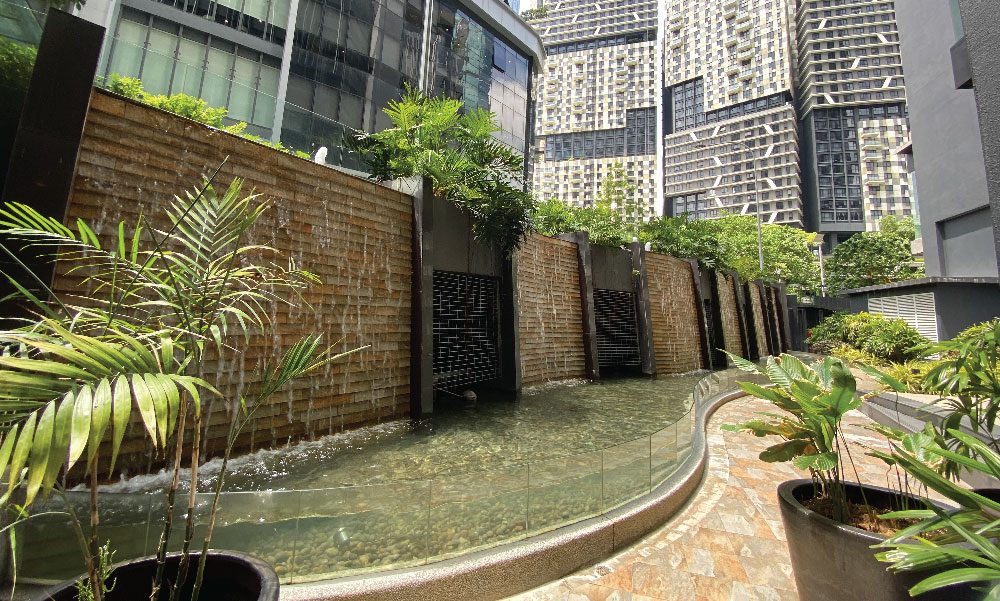 South Link Lifestyle Apartments: a water wall and garden between the towers