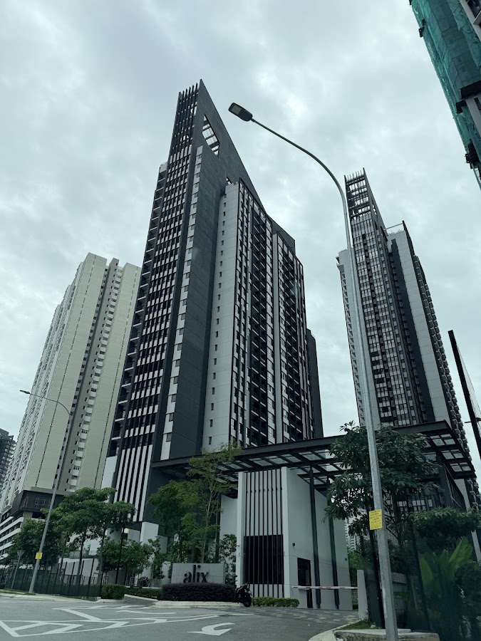 ALIX Residences: the towers from the street, with the ALIX sign at the gate