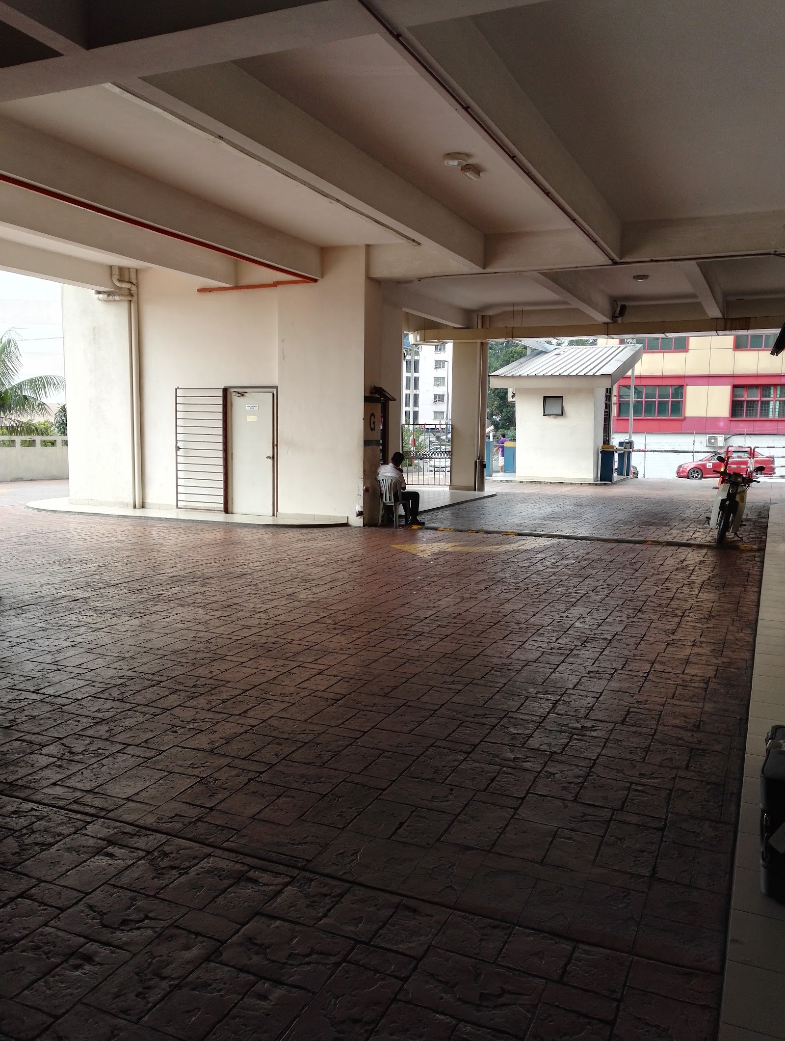 Serviced Residence @ Pelangi Damansara Sentral: Covered ground-floor porch/driveway area of a residential building with a security guard house and gate visible in the background