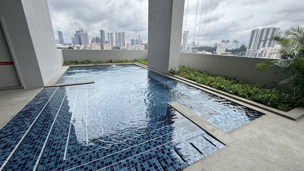 Nestree Residence: a pool on the facilities deck, the city beyond