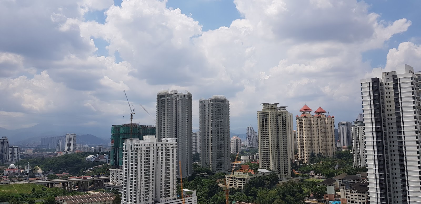 Kiara 9 Residency: Skyline view of high-rise residential towers under a cloudy sky, taken from a high vantage point