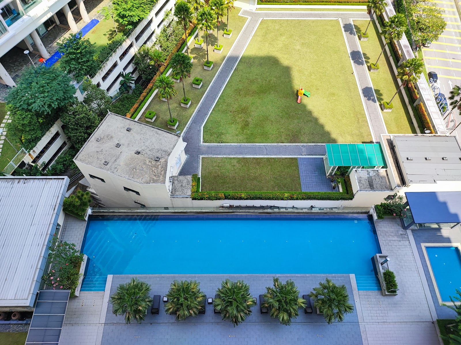 Camellia Serviced Suites: Aerial view of a residential development's swimming pool, lawn, and landscaped grounds