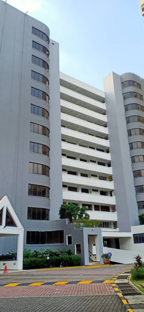 Menara Hartamas: A high-rise residential apartment tower viewed from ground level, showing its facade, balconies, and entrance area