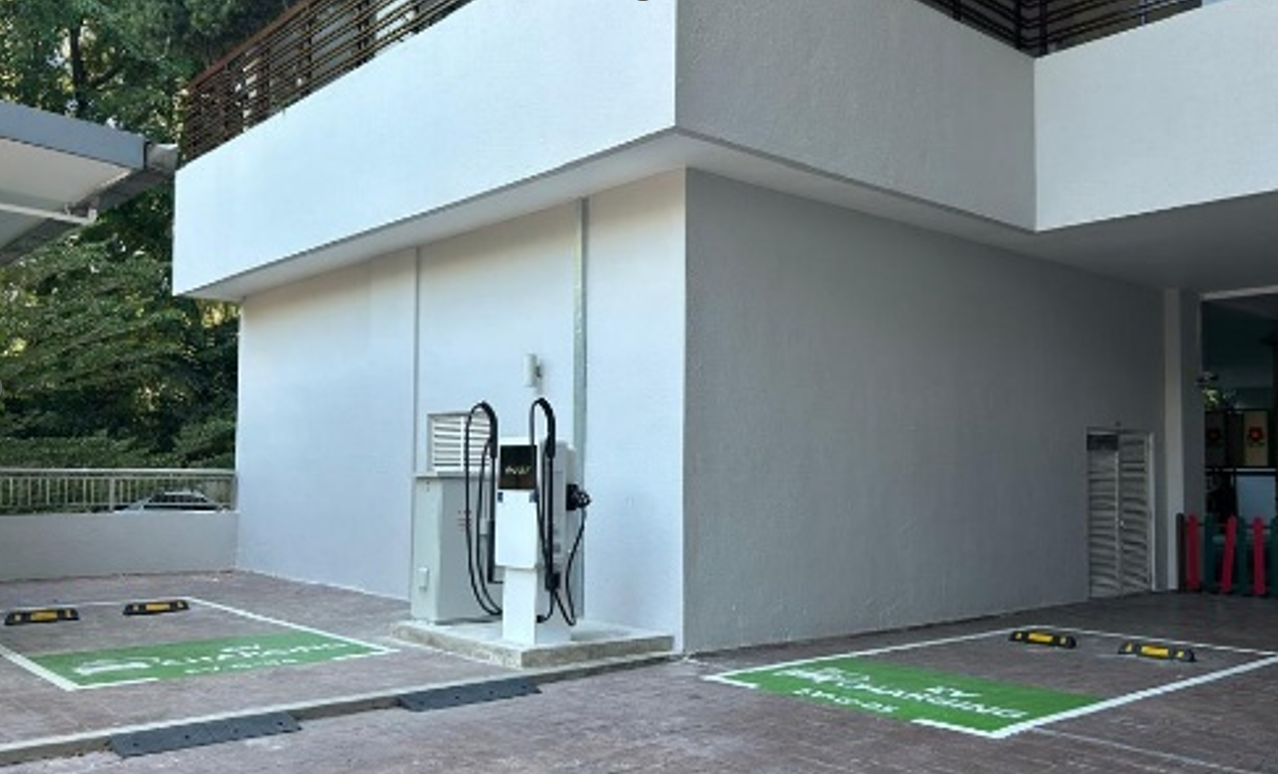 9 Bukit Utama: EV charging station with two parking bays marked for EV parking near a building's exterior wall