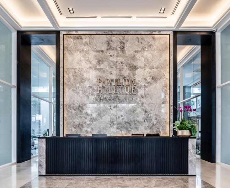 Pavilion Hilltop: Lobby reception desk with marble wall bearing Pavilion Hilltop lettering