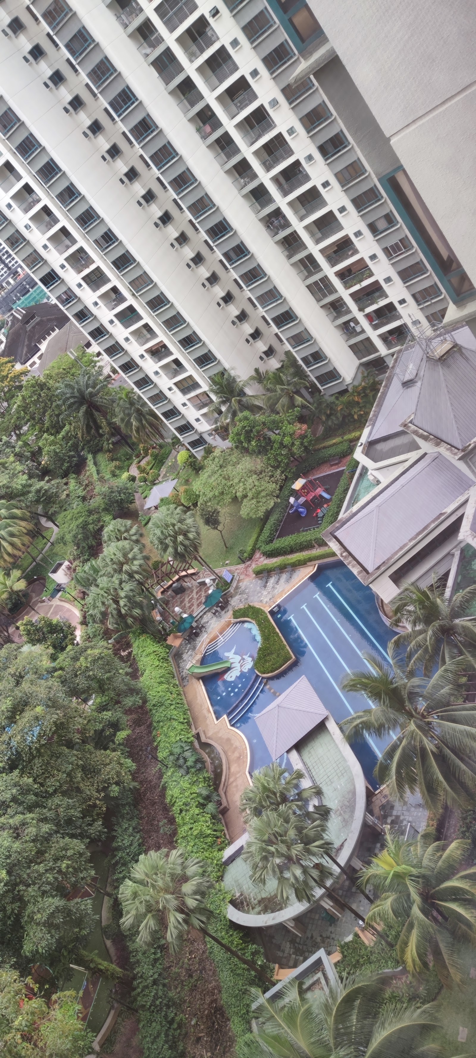 Mont Kiara Astana: Aerial view of a condominium's swimming pool, garden, and playground area surrounded by tower blocks and trees