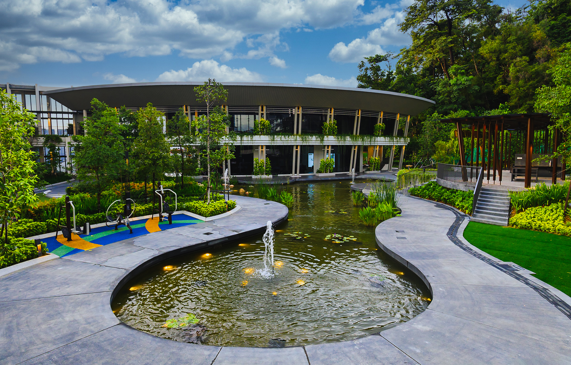 The Goodwood Residence: the pond and clubhouse among the gardens