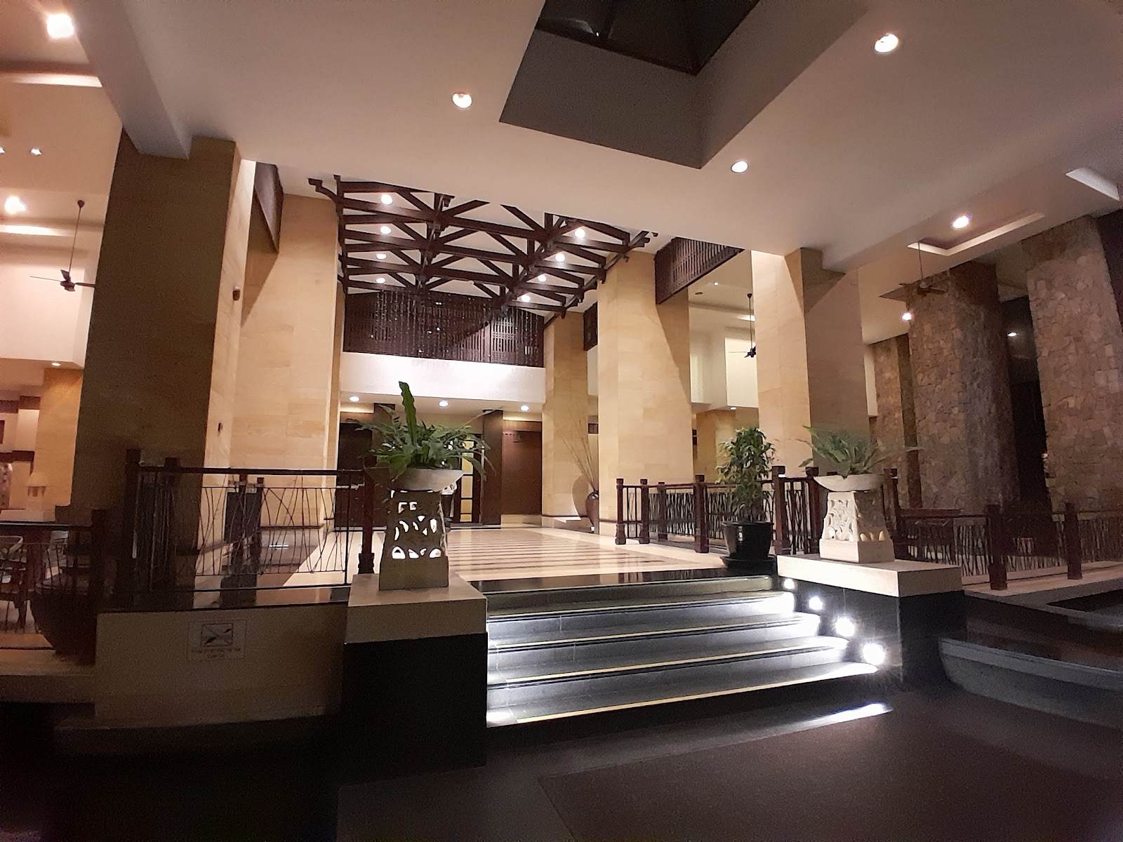 Mont Kiara Damai Resort Condominium: Interior lobby area with staircase, decorative wooden ceiling structure, potted plants, and stone pillars