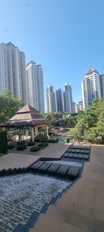 Mont Kiara Aman: a water feature and gazebo in the grounds, towers beyond