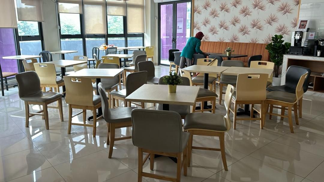 Residensi Cahaya: Dining area with tables and chairs, likely a breakfast or common eating area in a residential development