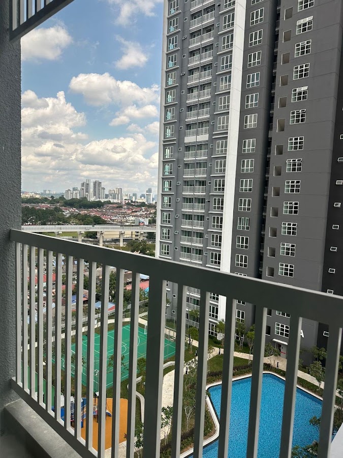 121 Residences: a neighbouring tower and the pool deck from a balcony, the city beyond
