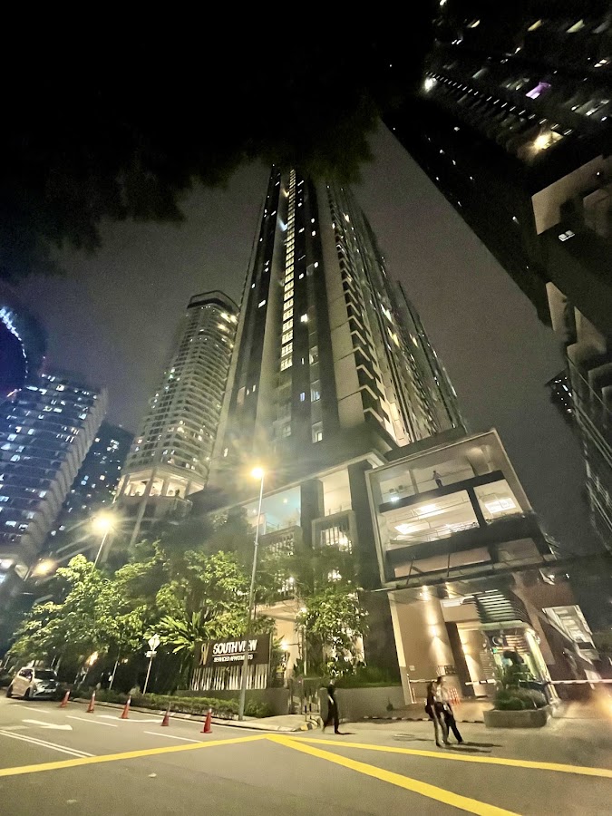 South View: the tower at night from the street, its entrance lit