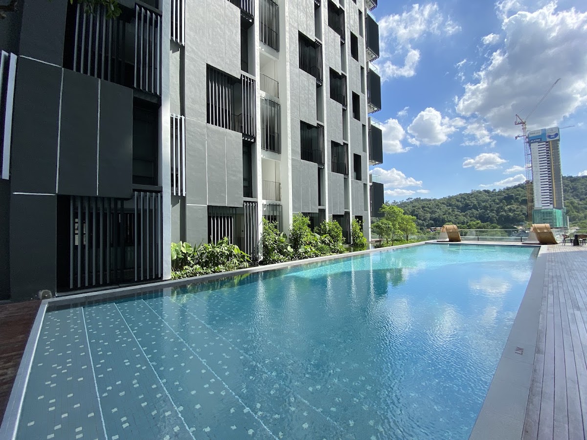 TWY Mont Kiara: the lap pool along the building, a green hill beyond