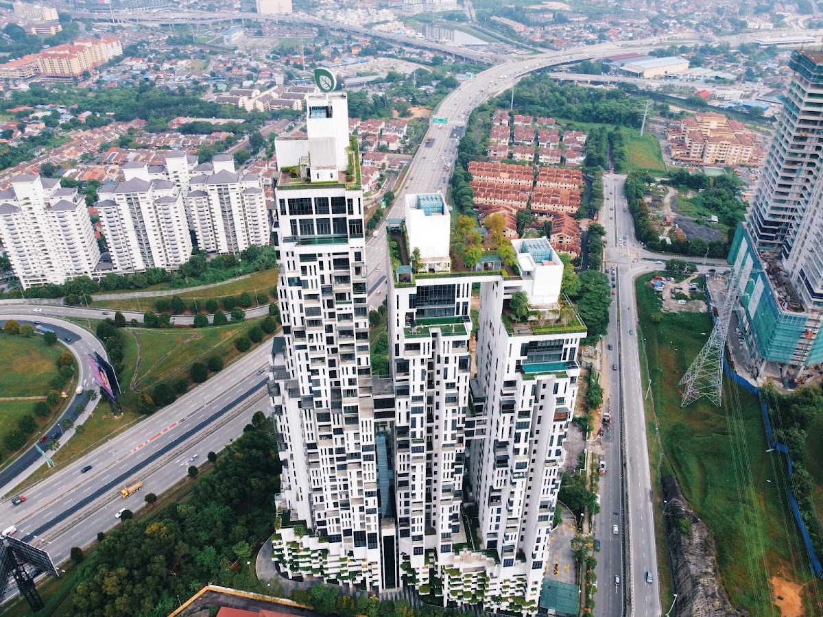 Icon Residence: the white stacked towers from the air, beside the highway