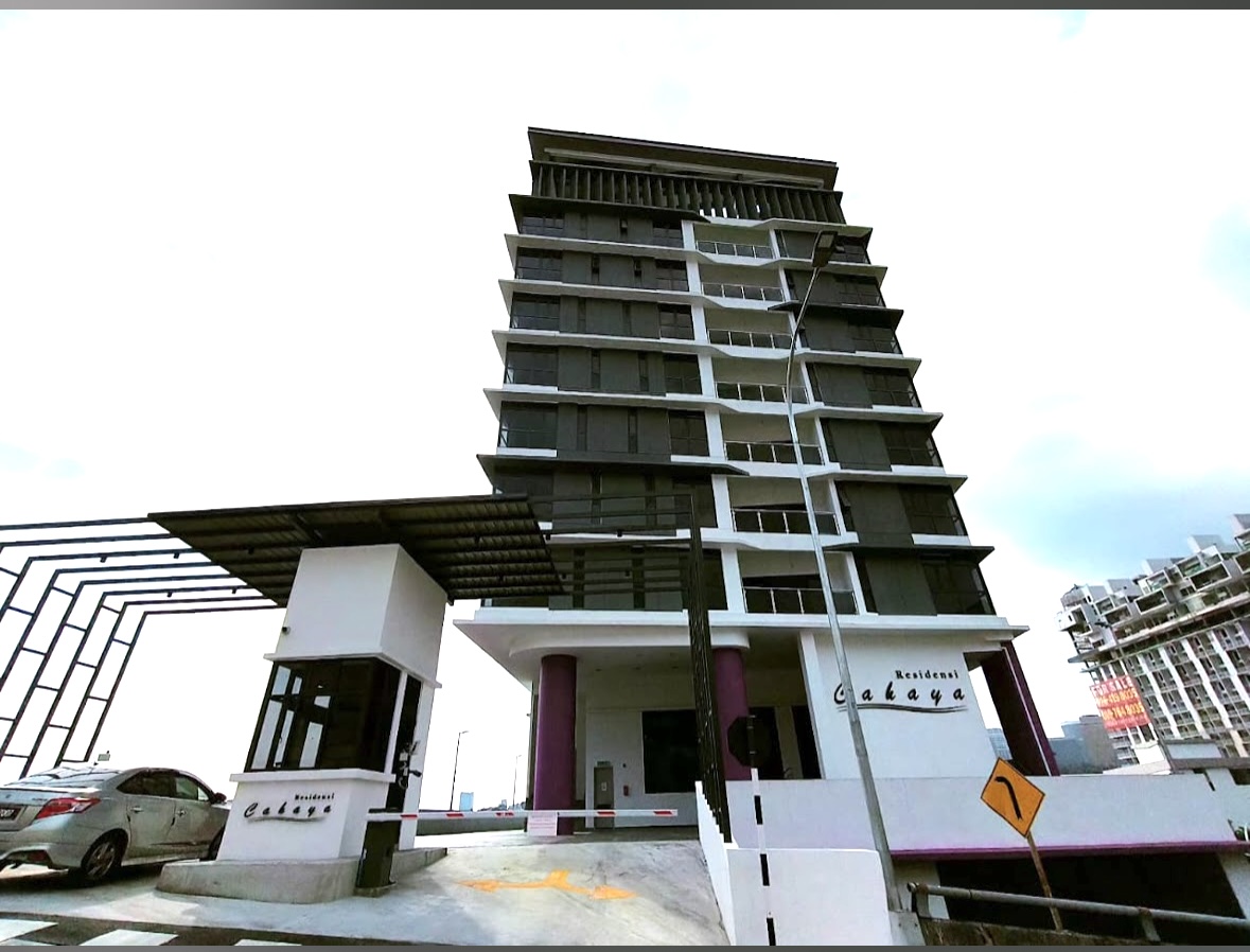 Residensi Cahaya: Front view of a residential tower named Residensi Cahaya with a guardhouse and boom gate at the entrance