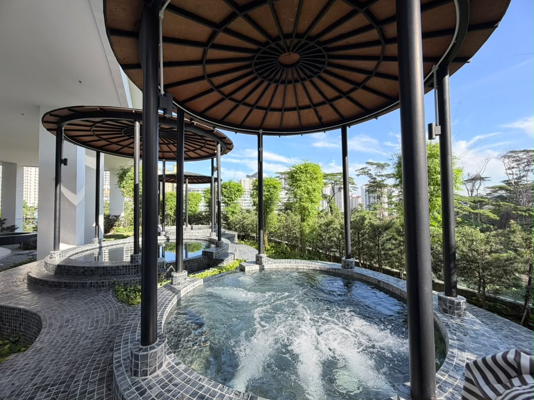 Kami: Outdoor jacuzzi pools with circular pavilion canopies overlooking a treetop cityscape view