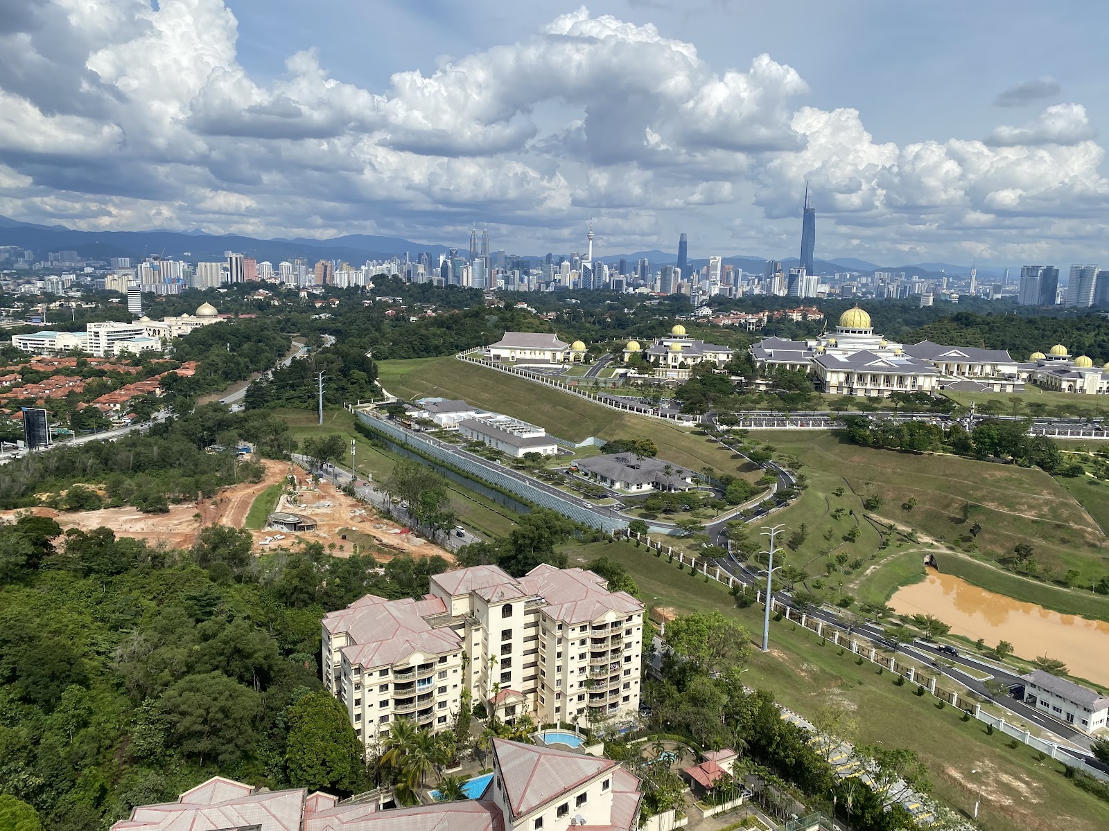 Windsor Tower: Aerial view from a high-rise showing a cityscape skyline in the distance, palace grounds with golden-domed buildings, and residential developments in the foreground