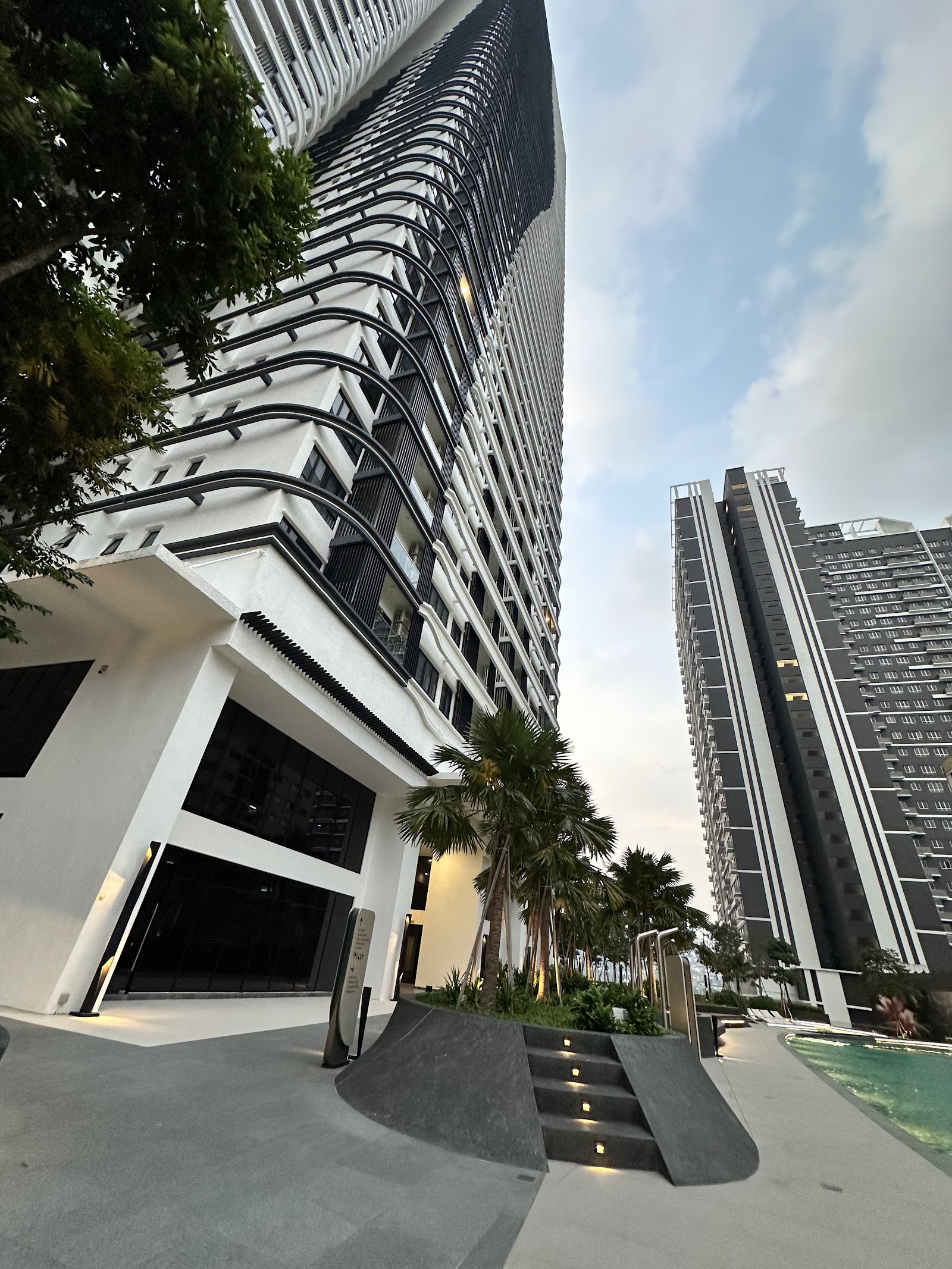 Bangsar Hill Park: Exterior view of residential towers with a landscaped entrance walkway, palm trees, and pool area