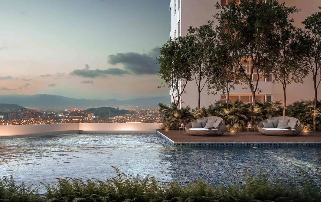 Artist's impression of Solasta Dutamas: pool at dusk with two round rattan daybeds on a timber deck, tower behind and city lights and hills beyond