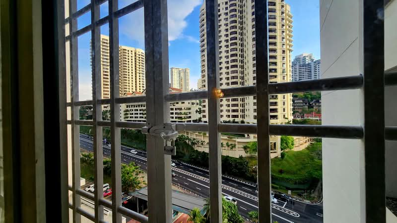 Menara Bangsar: Outlook through a window grille over a highway, greenery and residential towers