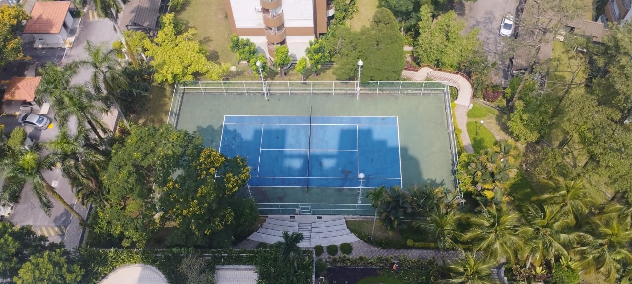 Bangsar Puteri: Aerial view of a tennis court surrounded by greenery within a residential development
