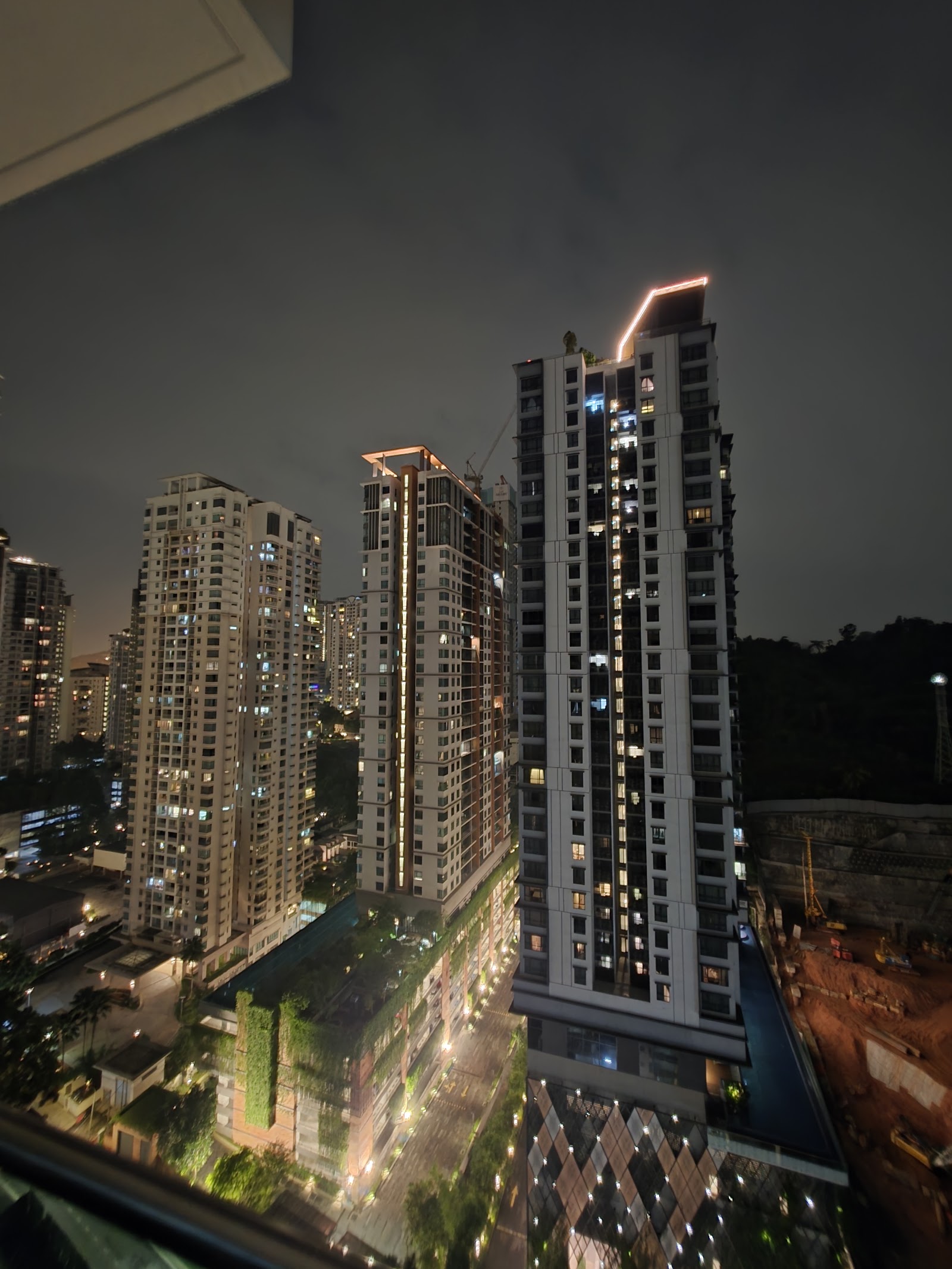Kiara 9 Residency: Night view of high-rise residential towers with lit windows, seen from an upper-floor vantage point