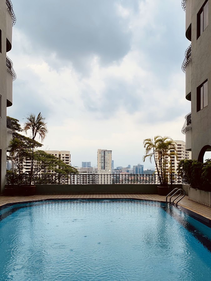 Merak Kayangan Court: the pool between the blocks, the city beyond