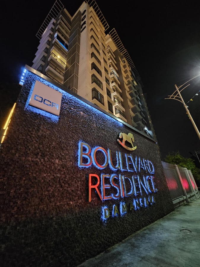 Boulevard Residence: the illuminated Boulevard Residence sign below the tower at night