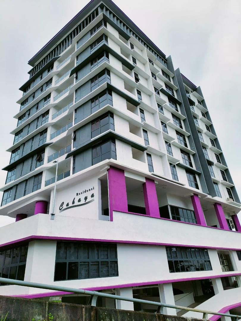 Residensi Cahaya: Exterior view of a multi-story residential building called Residensi Cahaya, with white facade, dark window frames and purple accent pillars