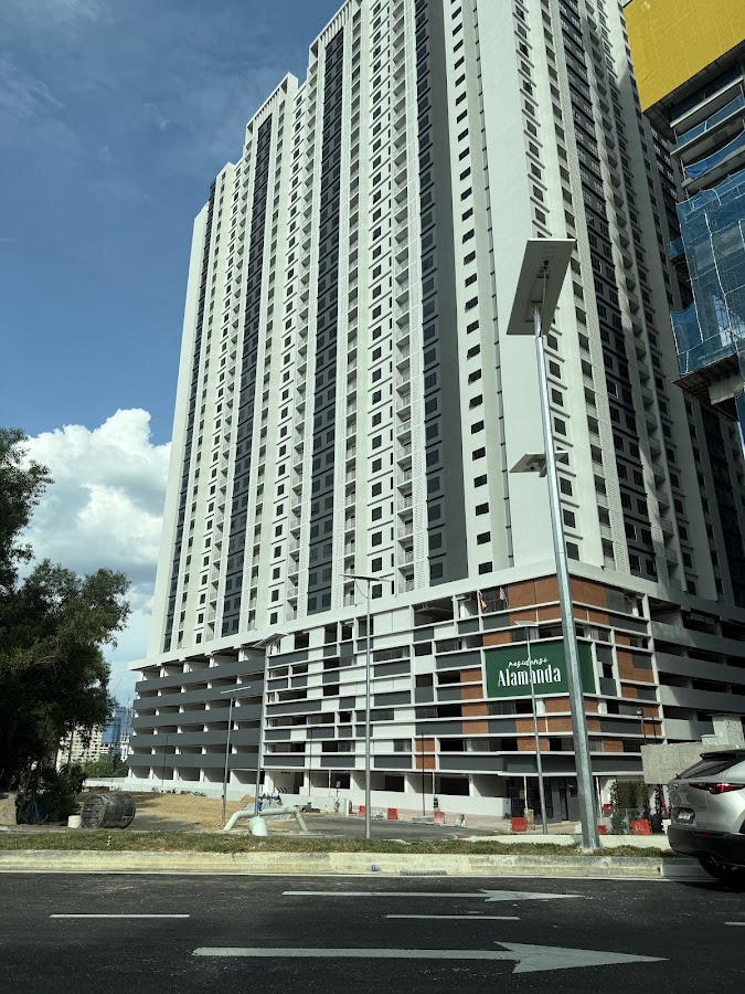 Residensi Alamanda: the tower from the street, its name on the car-park podium