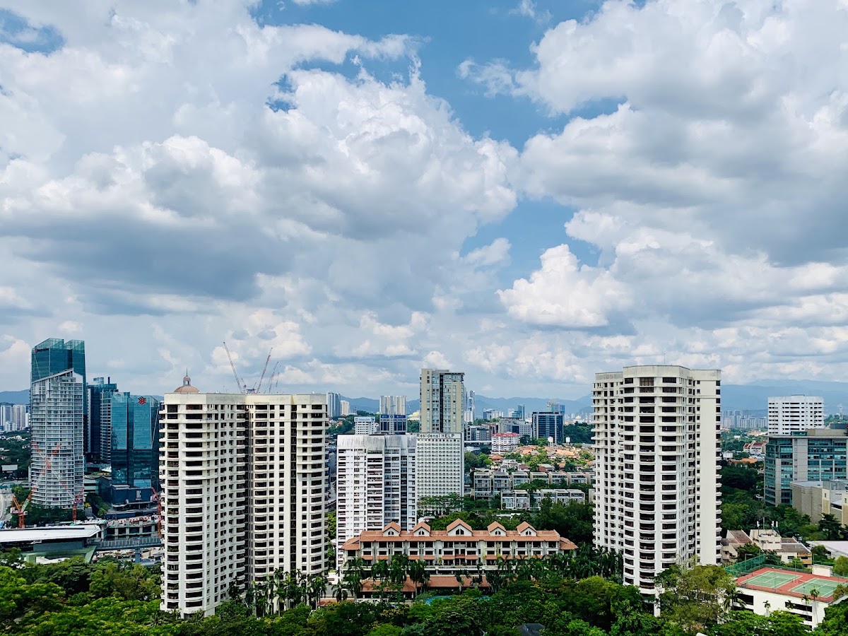 Merak Kayangan Court: towers and green hills of the neighbourhood from a high floor