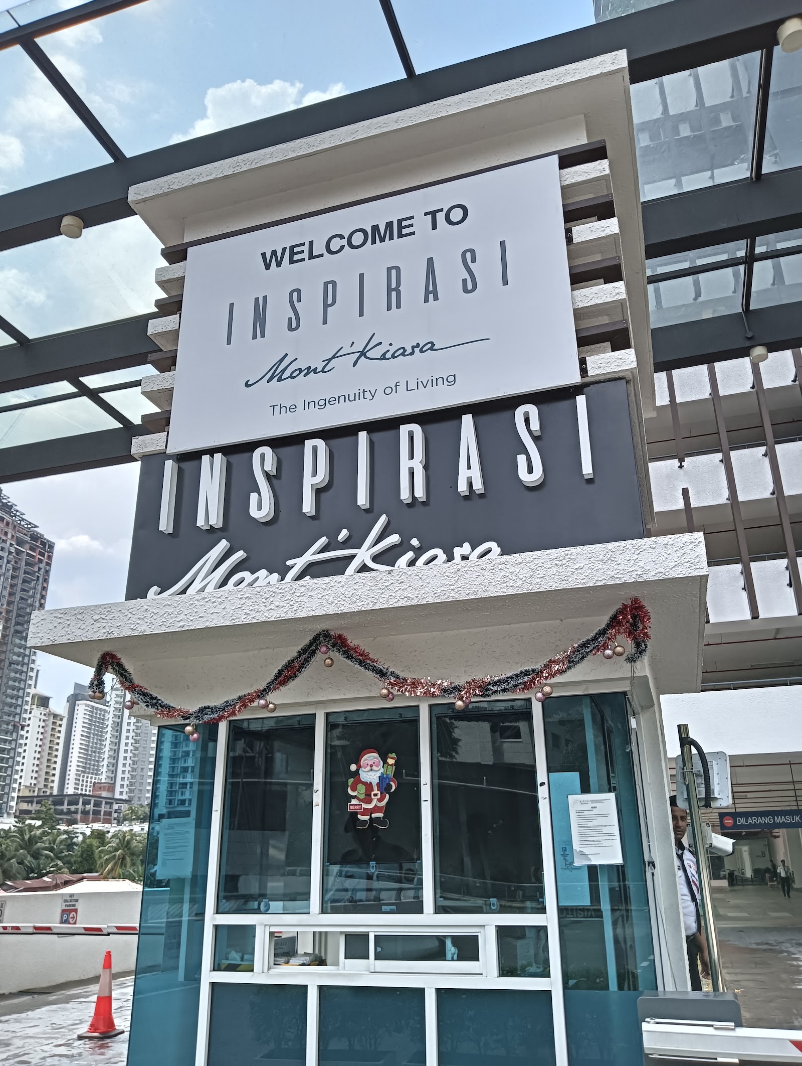 Inspirasi: Entrance signage of Inspirasi Mont'Kiara development with welcome sign and glass doors decorated with tinsel