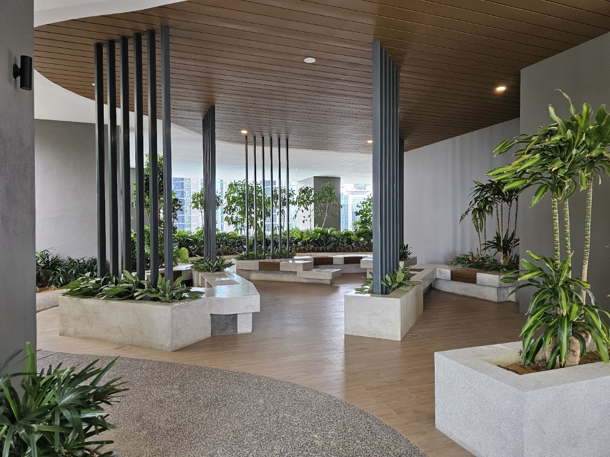 Laurel Residence: a covered lounge with built-in seating among planters