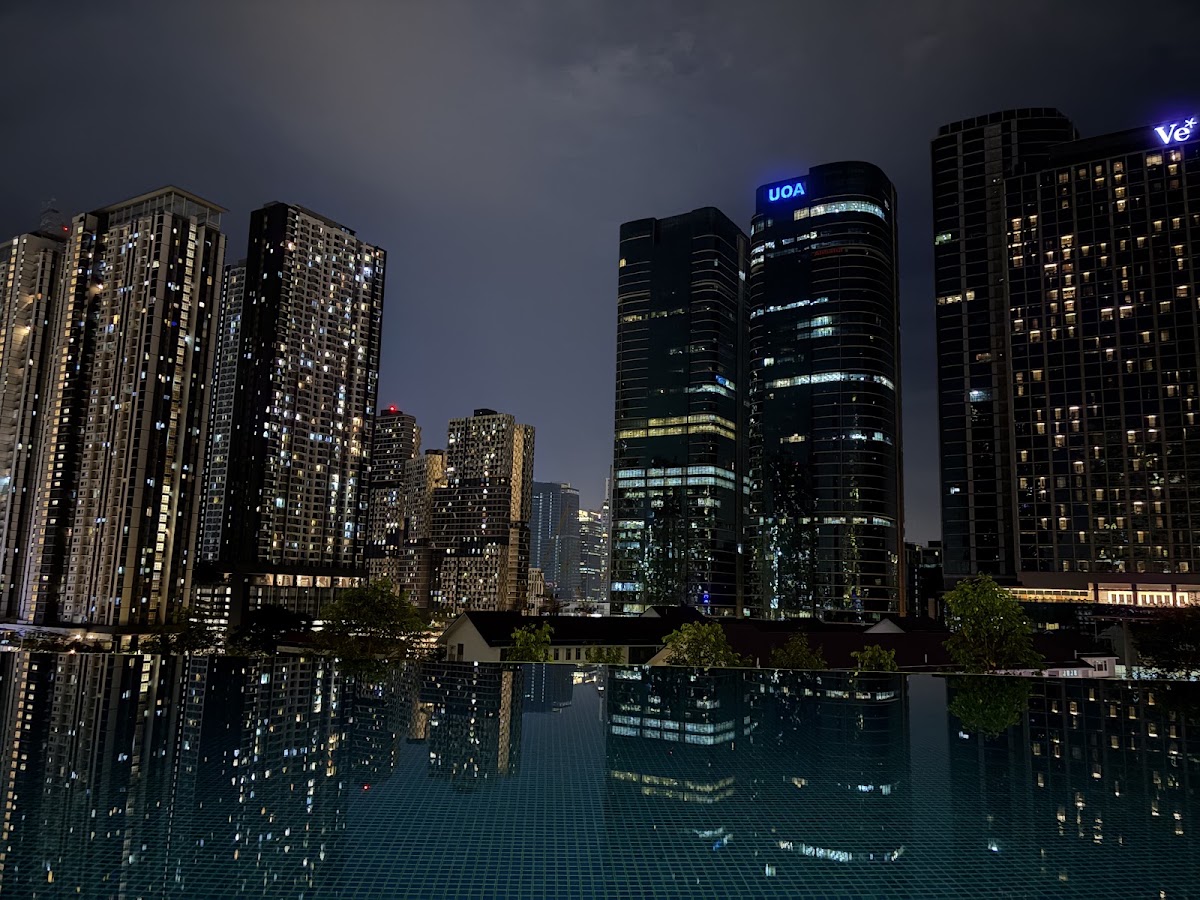 Acacia @ The Park Residences: office towers at night reflected in the infinity pool