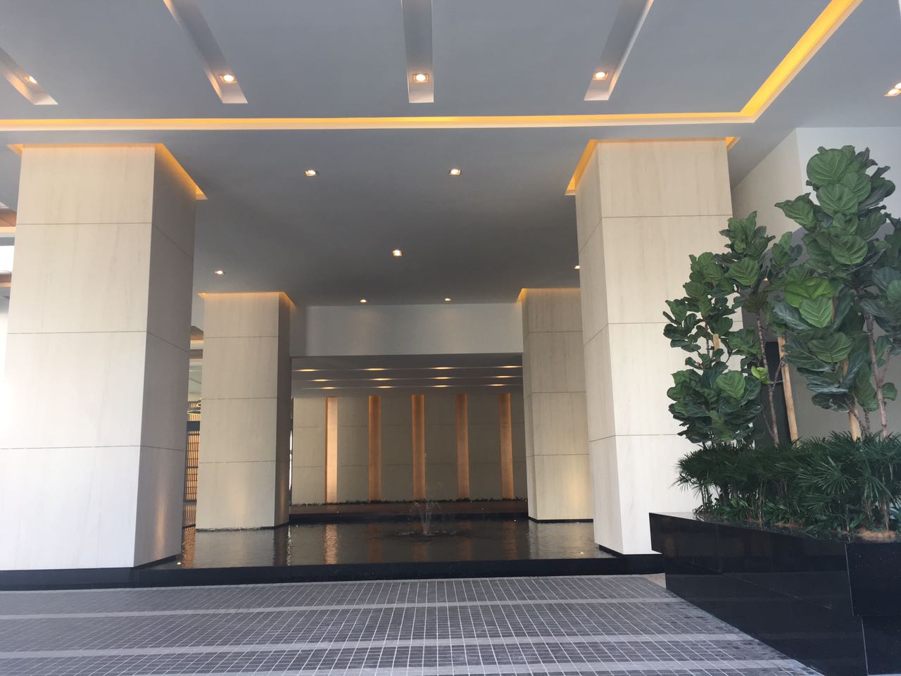Bangsar Permai: Interior lobby entrance area with marble columns, reflecting water feature, and decorative plants