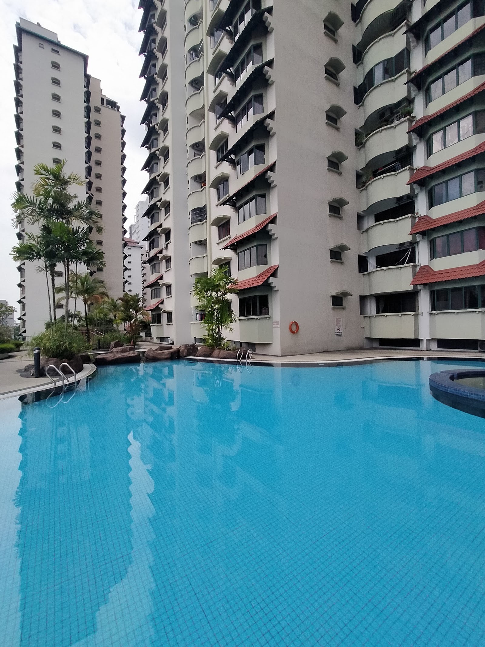 Desa Kiara: Swimming pool area of a residential condominium complex with high-rise towers surrounding it